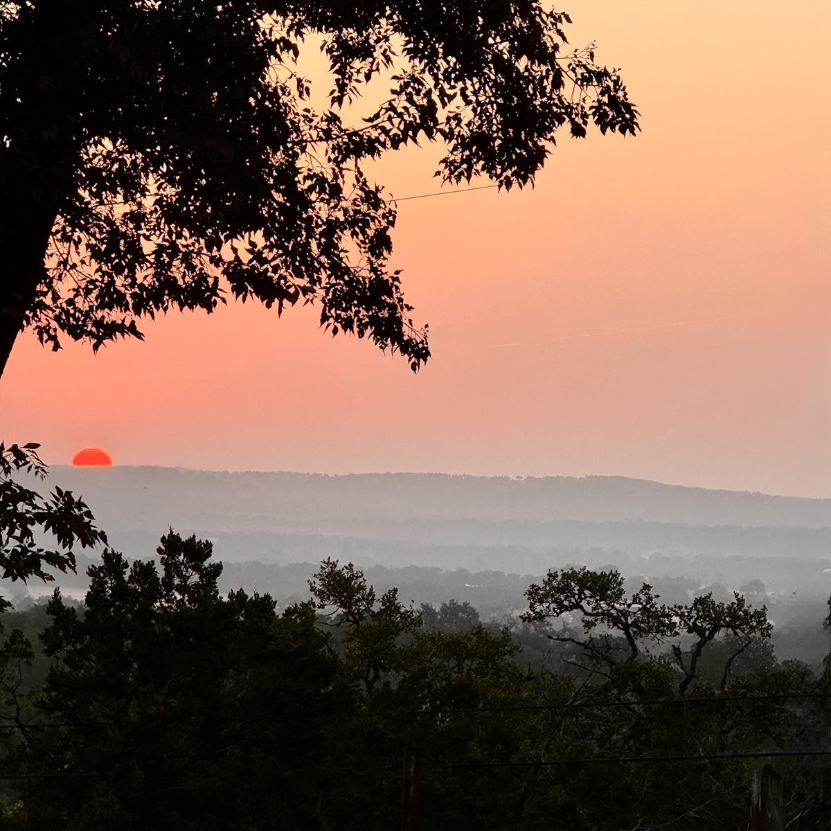 Sunrise over the Texas Hill Country from a backyard in Fredericksburg
